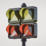 Photorealistic image of JSF dual-sided RRFB pedestrian crosswalk sign with flashing LED lights on a clean white background